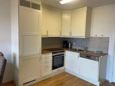 a kitchen with white cabinets and a sink at Leilighet for 4 i sentrum in Beitostøl
