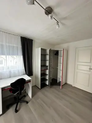 an empty room with a desk and a chair at Cozy house with a sea view in Knarrvika