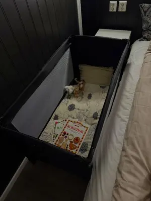a suitcase with a stuffed animal in it on a bed at Koselig ved Fjorden - Vangsnes in Vangsnes