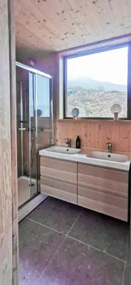 a bathroom with two sinks and a large window at Modern Lines And Coziness In Hemsedal in Hemsedal