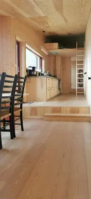an empty room with a bench and a kitchen at Modern Lines And Coziness In Hemsedal in Hemsedal