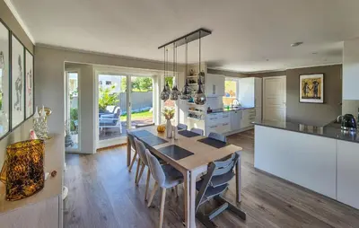 a kitchen and dining room with a table and chairs at Beautiful Home In Bjørøyhamn With House Sea View in Nord Bjørøy