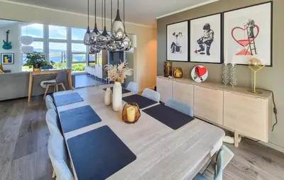 a dining room with a table and blue chairs at Beautiful Home In Bjørøyhamn With House Sea View in Nord Bjørøy