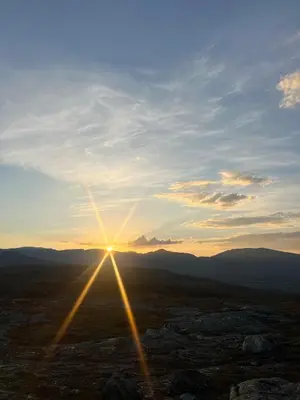 a sun setting in the middle of a field at New cabin in beautiful surroundings in Oppdal
