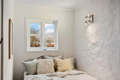a living room with a couch and a window at Charming apt in the centre of Bergen in Bergen