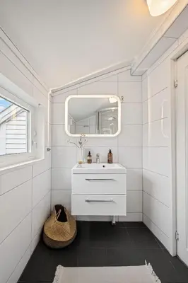 a bathroom with a sink and a mirror at Charming apt in the centre of Bergen in Bergen