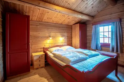 a bedroom with a bed in a wooden cabin at Lisetra 716A in Trysil
