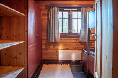 a small room with wooden walls and a window at Lisetra 716A in Trysil