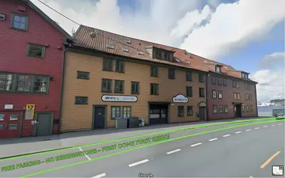 a large wooden building on the side of a street at L1SB18 - Central 2BR Hideaway in Bergen