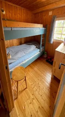 a room with two bunk beds and a chair at Family Cabin At Birkebeiner Slopes In Sjusjøen in Sjusjøen