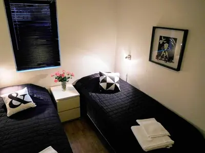 a small room with two beds and a vase of flowers at 6 person holiday home in Sørbøvåg in Sørbø