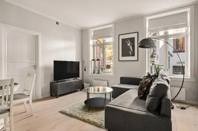 a living room with a couch and a table at Bergen Beds Apartments - A Front Row Experience in Bergen