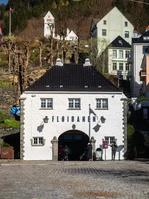 a white building with a black roof and a tunnel at Bergen Beds Apartments - A Front Row Experience in Bergen