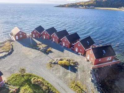a group of houses on an island in the water at Seaside Retreat with Boats & Fishing in Brekstad