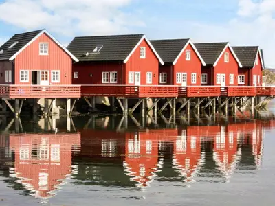 a row of houses on a pier over water at Seaside Retreat with Boats & Fishing in Brekstad