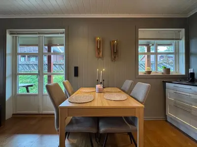 a dining room with a wooden table and chairs at Cozy apartment in Vestlia, Geilo in Geilo