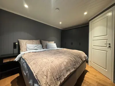 a bedroom with a large bed and a white door at Cozy apartment in Vestlia, Geilo in Geilo