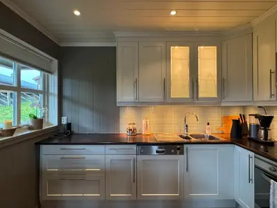 a kitchen with white cabinets and a sink at Cozy apartment in Vestlia, Geilo in Geilo