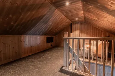 a room with a wooden ceiling with a bed in it at Ski centre, sauna, hot tub