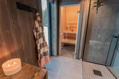 a bathroom with a shower and a toilet and a shower curtain at Ski centre, sauna, hot tub