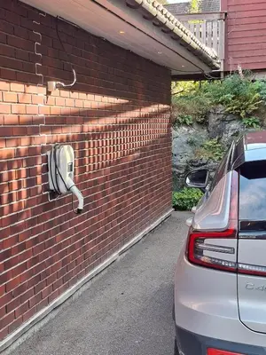 a brick wall with a pay phone on it at Villa with lake view in Lunde