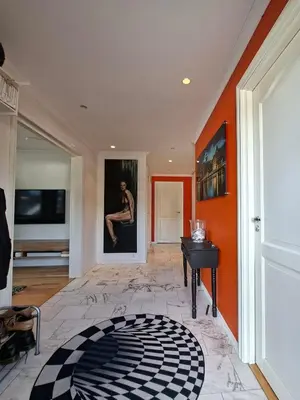 a bedroom with an orange wall and a black piano at Villa with lake view in Lunde