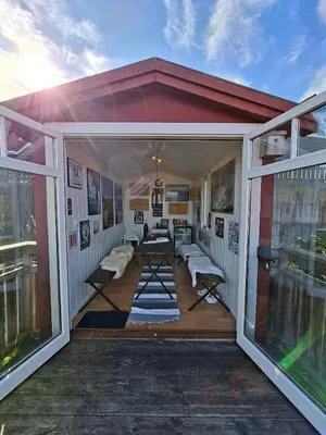 a screened in porch of a house with windows at Villa with lake view in Lunde
