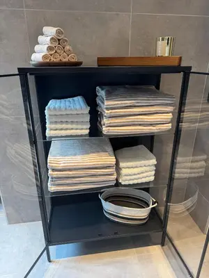a glass shelf with towels on it at Bergen city centre, fantastic, new apartment in Bergen