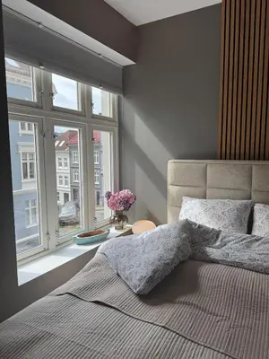a bedroom with a large bed and a window at Bergen city centre, fantastic, new apartment in Bergen
