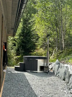 a microwave sitting on the gravel next to a building at Robelia - Sauna, Hot tub - Norefjell ski center in Noresund
