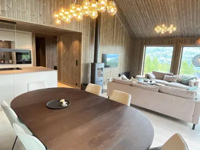 a kitchen and living room with a table and a couch at Robelia - Sauna, Hot tub - Norefjell ski center in Noresund