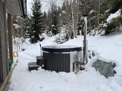 a trash can in the snow next to a house at Robelia - Sauna, Hot tub - Norefjell ski center in Noresund
