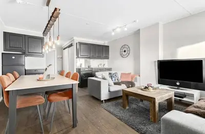 a living room with a couch and a table at Mountain apartment Norefjell Ski in ski out in Surteberg