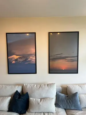 two pictures on the wall above a couch at Modern apartment with view in Lii