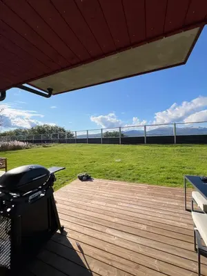 a deck with a grill and a grass field at Modern apartment with view in Lii