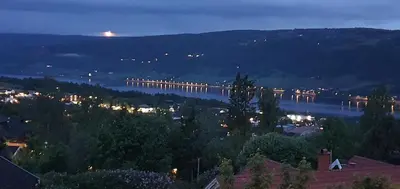 a view of a bridge over a river at night at Flora in Lillehammer
