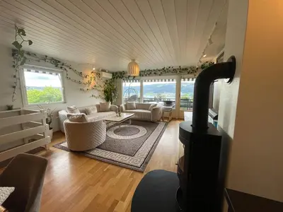 a living room with a wood stove in a room at Flora in Lillehammer