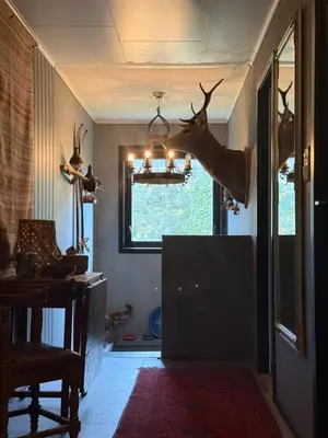 a room with a deer head hanging from a chandelier at Fossen bratte chalet in Eikedalen