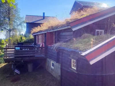 a building with a grassy roof with a house at 6 person holiday home in LEKSVIK in Leksvik