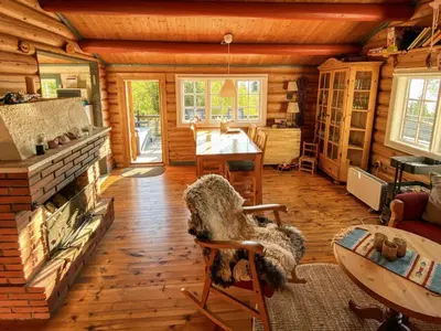a living room with a fireplace in a log cabin at 6 person holiday home in LEKSVIK in Leksvik