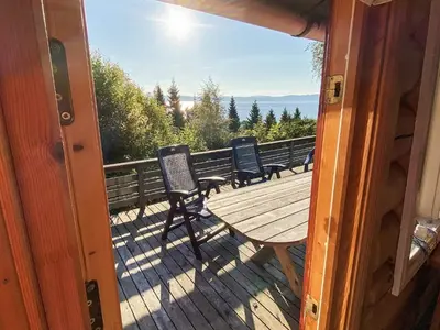 a porch with a wooden table and chairs on a deck at 6 person holiday home in LEKSVIK in Leksvik
