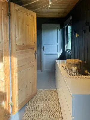 a door leading to a kitchen with a table and a counter at Cosy Family Cabin With Views And Sauna in Svingvoll