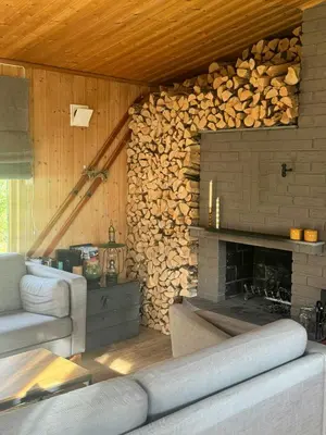 a living room with a fireplace and a couch at Cosy Family Cabin With Views And Sauna in Svingvoll