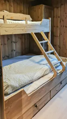 a bunk bed in a wooden cabin with a mattress at Modern Family Cabin Near Kikut In Geilo in Geilo