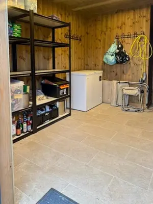 a kitchen with a refrigerator and a chair in a room at Modern Family Cabin Near Kikut In Geilo in Geilo