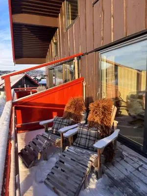 two benches sitting on a deck in the snow at Beautiful apartment at Ustaoset in Hol