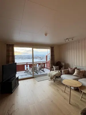 a living room with a couch and a television and a table at Beautiful apartment at Ustaoset in Hol