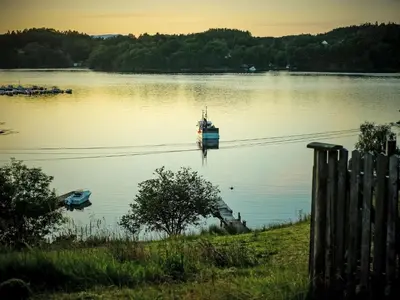 a boat in the middle of a lake at Holiday Home Lauvlid Cottage by Interhome in Tysnes