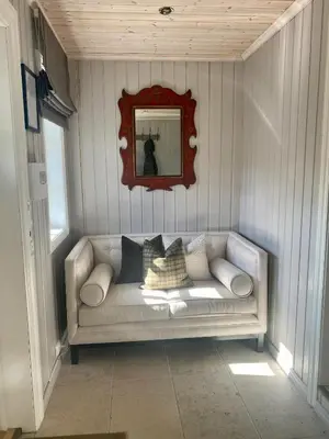 a white couch in a room with a mirror at Bjarnebu - 4 bedroom cabin in Rauland in Rauland