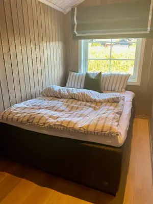 a bed in a room with a window at Bjarnebu - 4 bedroom cabin in Rauland in Rauland
